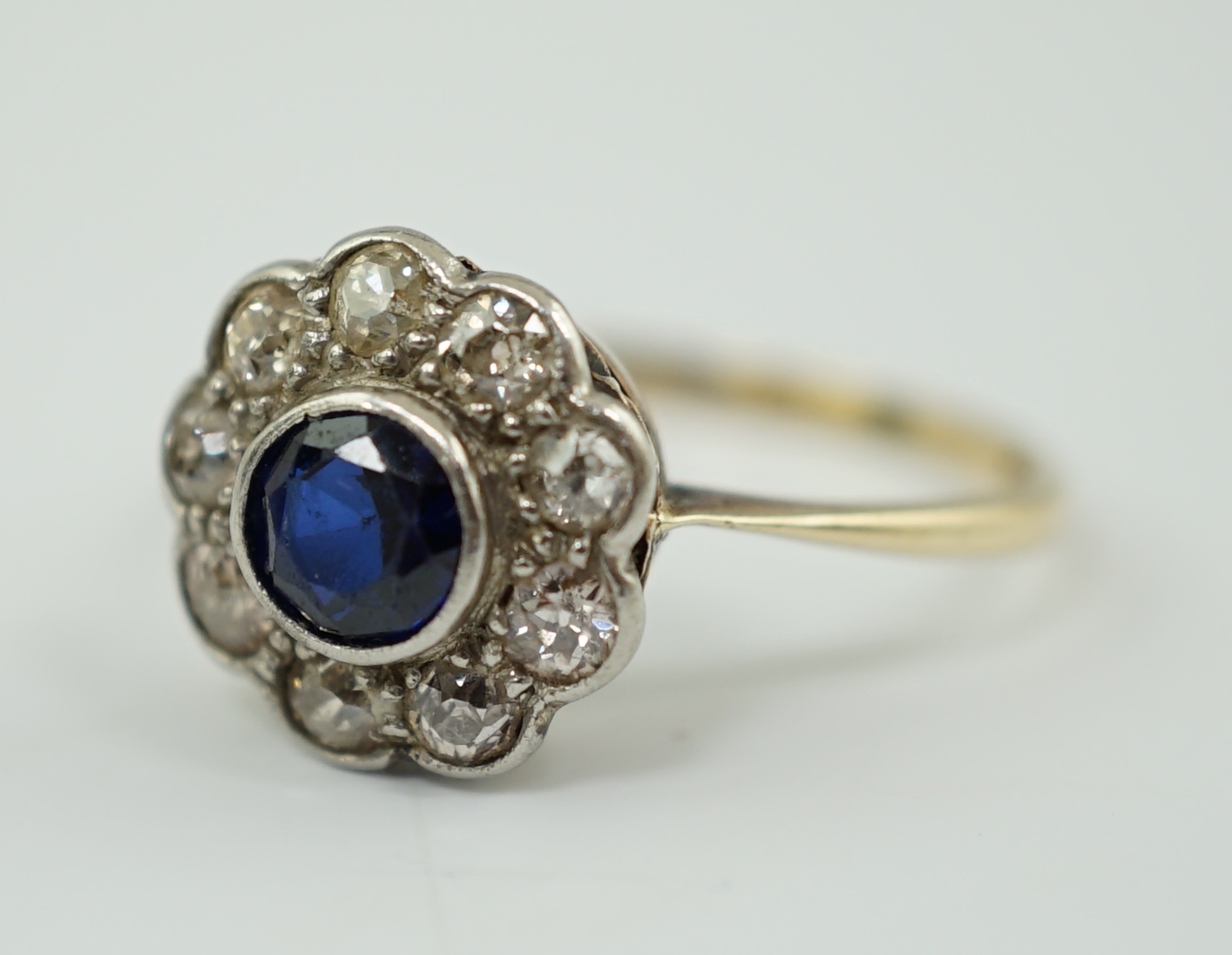 A 1920's 18ct gold, sapphire and diamond set flower head cluster ring